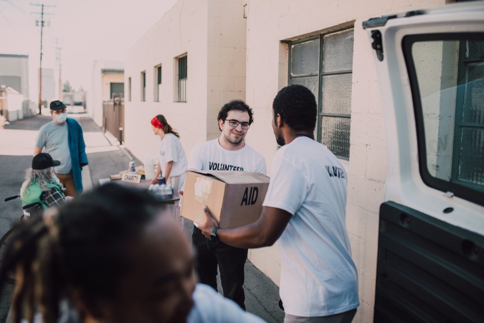 Volunteers carrying an aid box